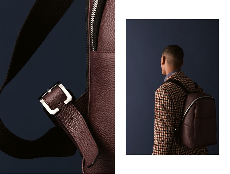 Wearing Canali, Selim dons a luxurious leather backpack in brown.