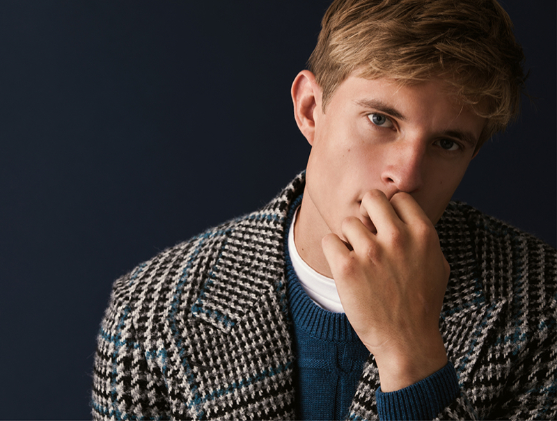 Color coordinating, Ruben sports a tweed coat with a sweater by Canali.