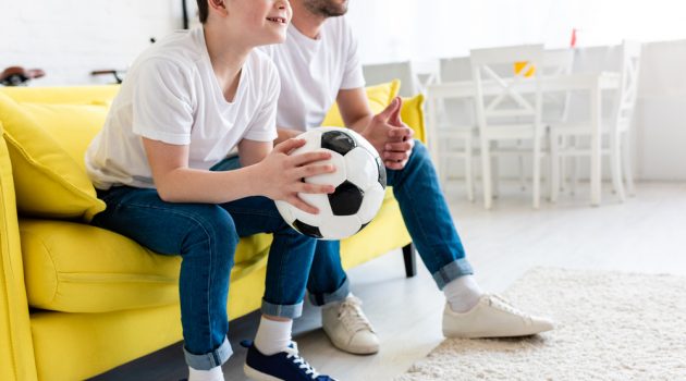 5 Money Saving Tips for Families & Households on a Budget Father Son Watching TV