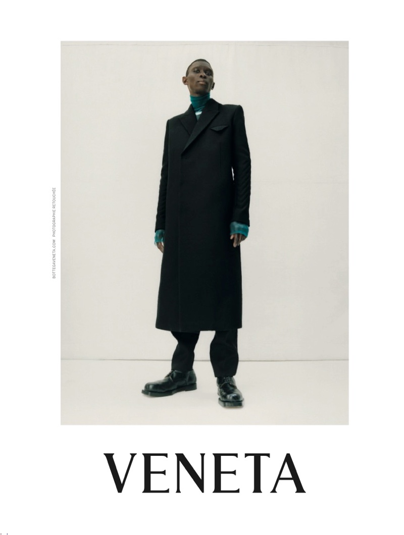 Donning a long coat, Fernando Cabral appears in Bottega Veneta's fall-winter 2019 campaign.