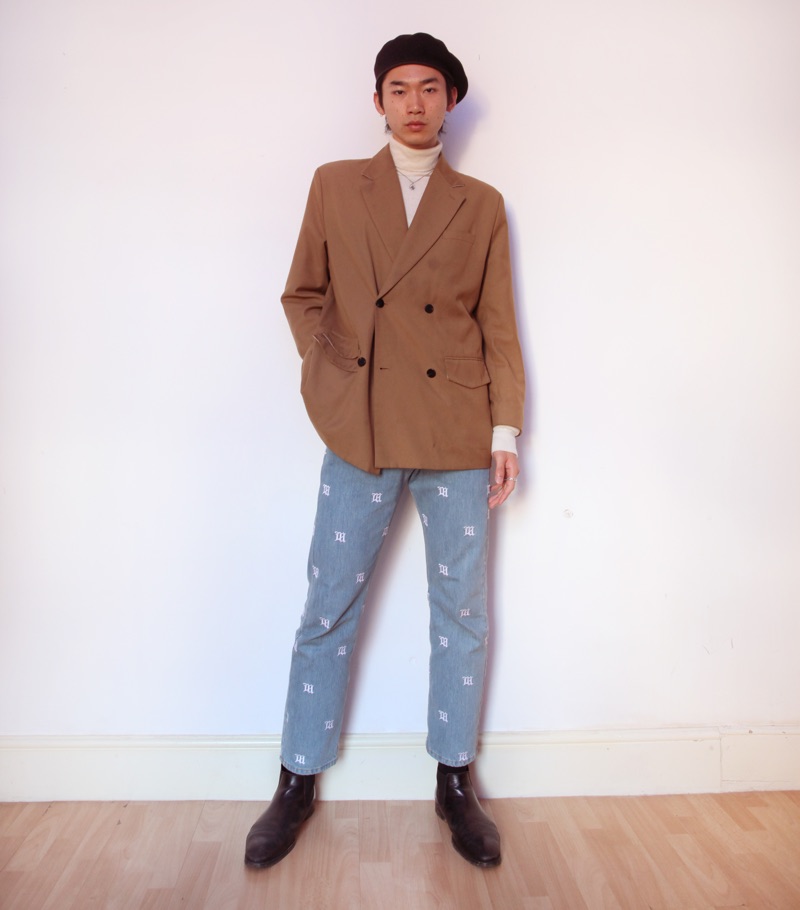 Hidetatsu wears beret SCHA, suit jacket Gentle x Cover, turtleneck Calvin Klein, necklace XU Harajuku, jeans MISBHV, and boots Dries Van Noten.