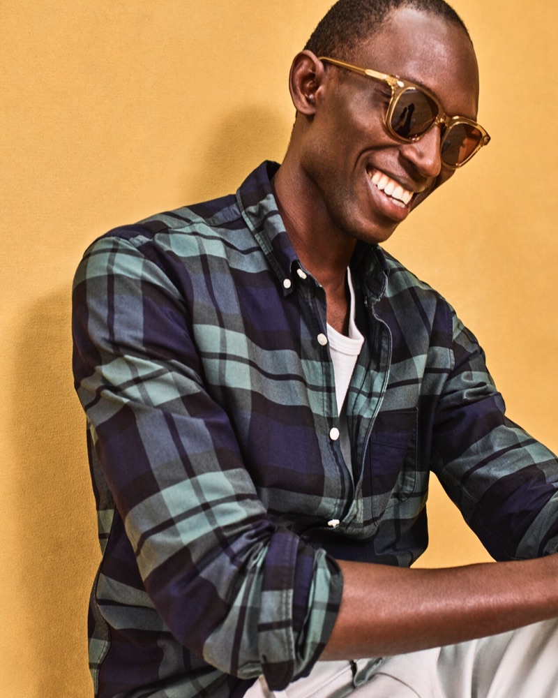 All smiles, Armando Cabral dons a J.Crew plaid oxford shirt $69.50.