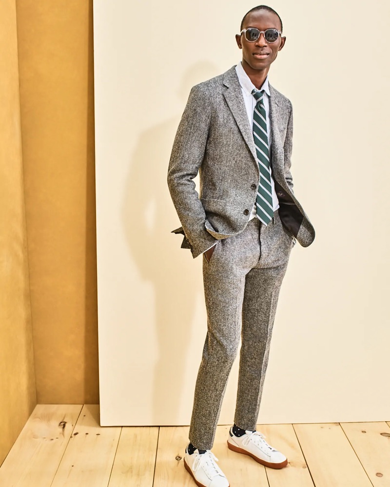 Model Armando Cabral dons a J.Crew Ludlow herringbone suit jacket $298 and pants $168 with a striped oxford shirt $69.50 and Wainscott sunglasses $59.50.