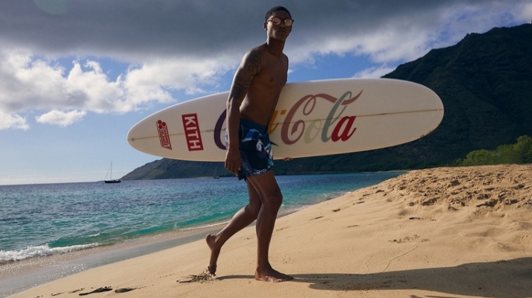 Taking to the beach, Timothy Lewis rocks swim shorts from the KITH x Coca-Cola capsule collection.