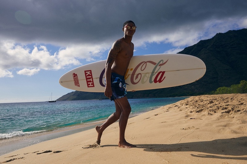 Taking to the beach, Timothy Lewis rocks swim shorts from the KITH x Coca-Cola capsule collection.