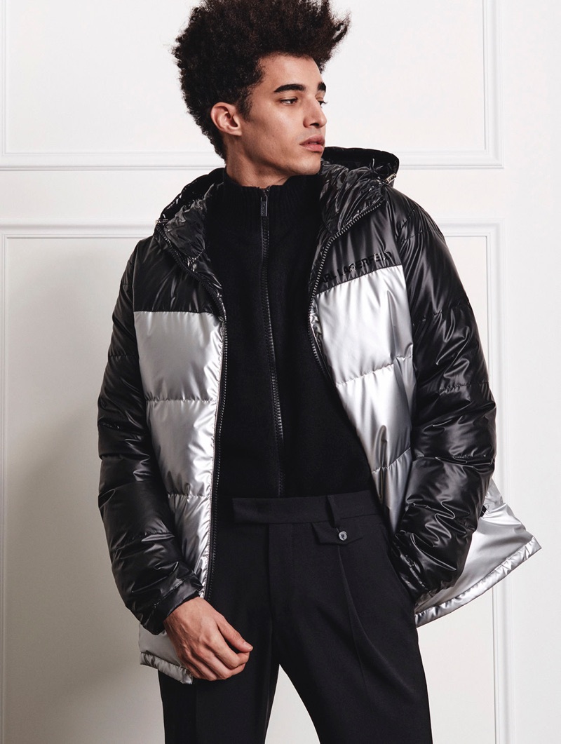Sporting a black and silver puffer jacket, Luis Borges wears Karl Lagerfeld.