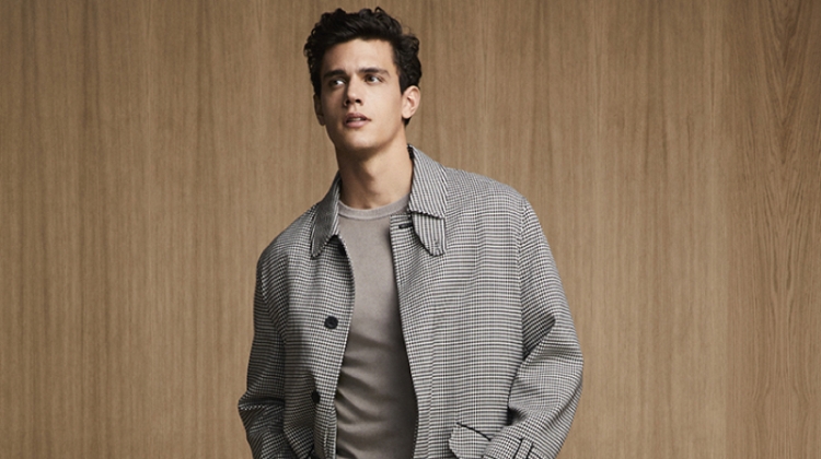 Xavier Serrano sports a chic checked coat with pleated trousers and a sweater from Liu Jo Uomo.