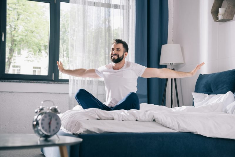 Man in Furnished Bedroom