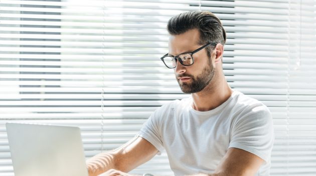 5 Ways to Market Your Brand at Conventions & Exhibitions Man on Laptop Wearing Glasses