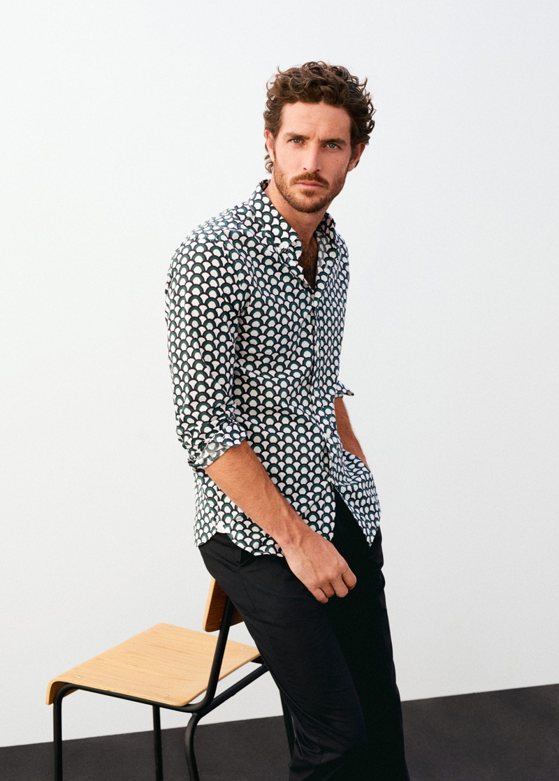 Justice Joslin sports a patterned shirt with pants from Mango.