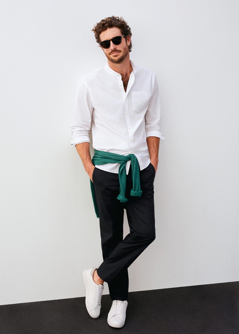 Making a case for smart essentials, Justice Joslin wears a grandad collar shirt with trousers and white sneakers.