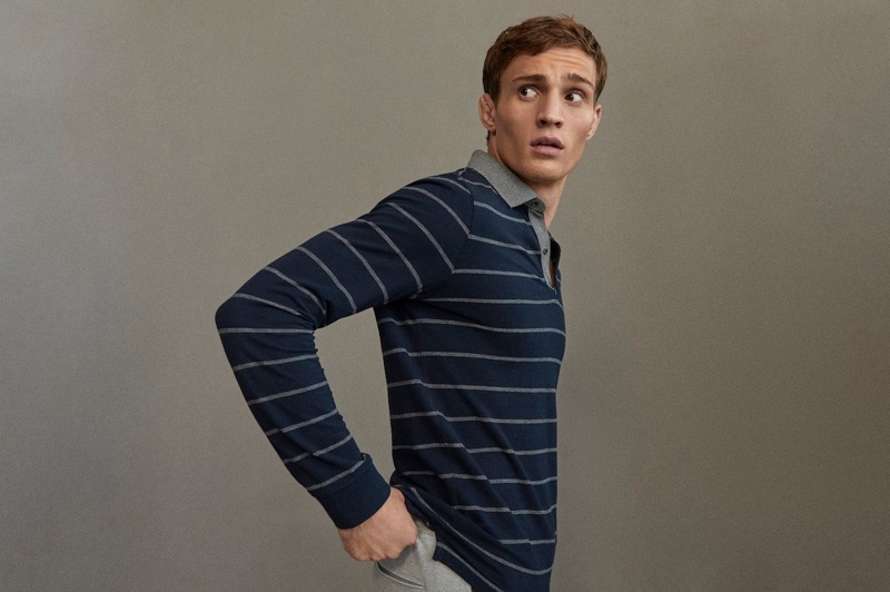 Donning a navy striped long-sleeved polo, Julian Schneyder showcases style from Massimo Dutti's Travel Soft collection.