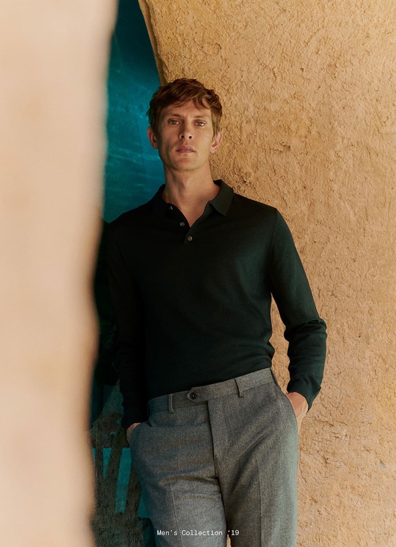 A smart vision, Mathias Lauridsen wears a long-sleeve polo and grey pleated trousers by Massimo Dutti.