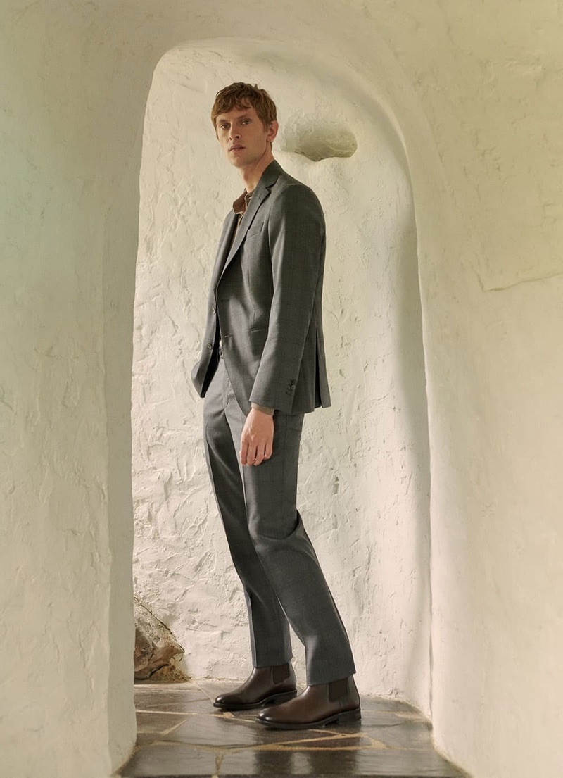 Danish model Mathias Lauridsen sports a grey suit and brown leather boots from Massimo Dutti.