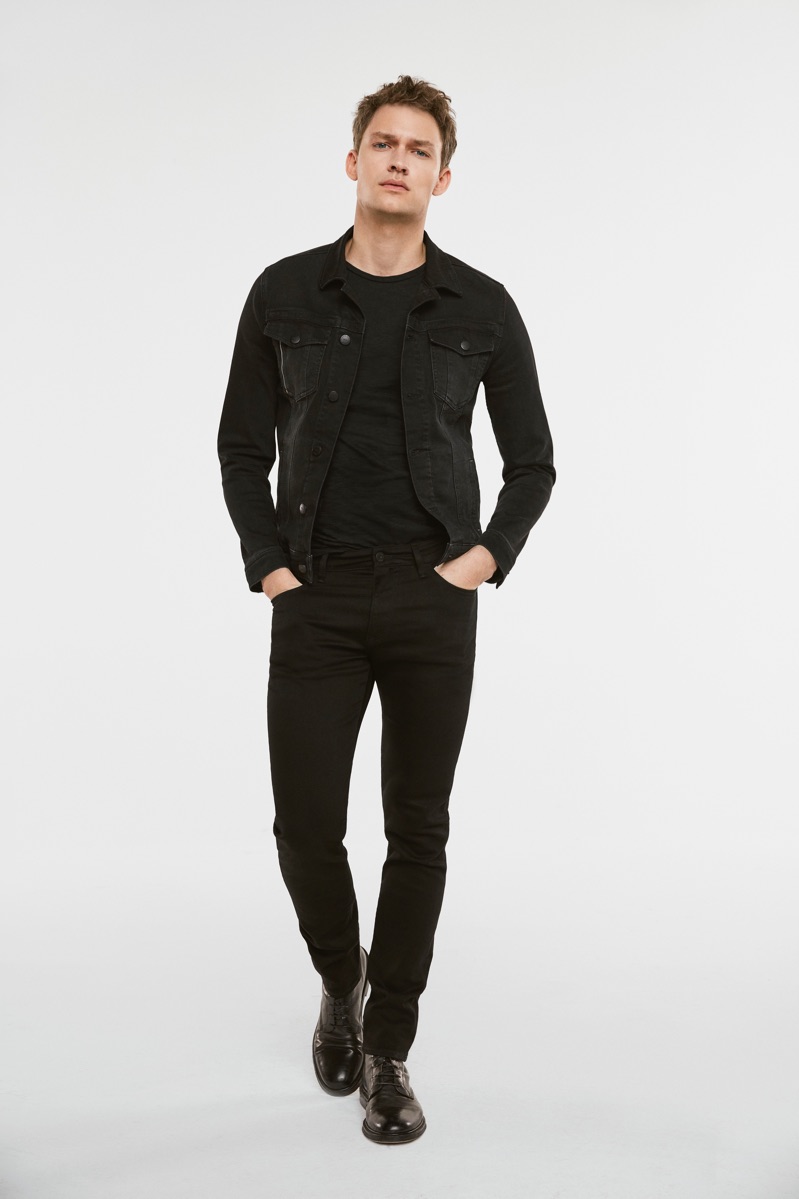 Dressed in black, Kristoffer Hougaard models Mavi's Frank denim jacket and James skinny leg jeans.