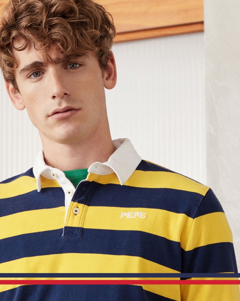 Tom Webb wears a yellow and navy striped polo from Pepe Jeans' archive-inspired Pepe collection.