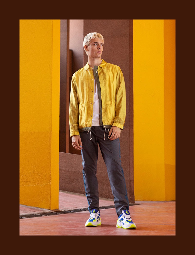 Standing out in yellow, João Knorr sports a jacket by Sacai.