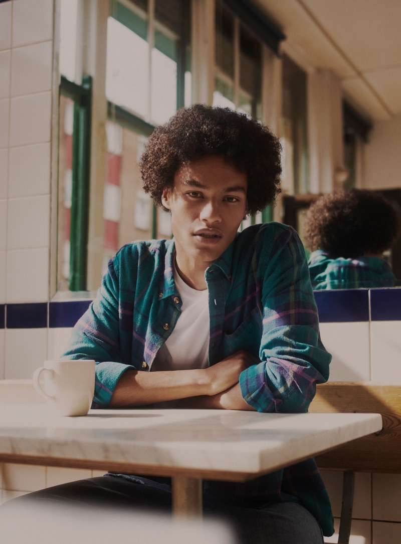 Joseph Griffin sports a flannel shirt with ripped jeans from Zara.