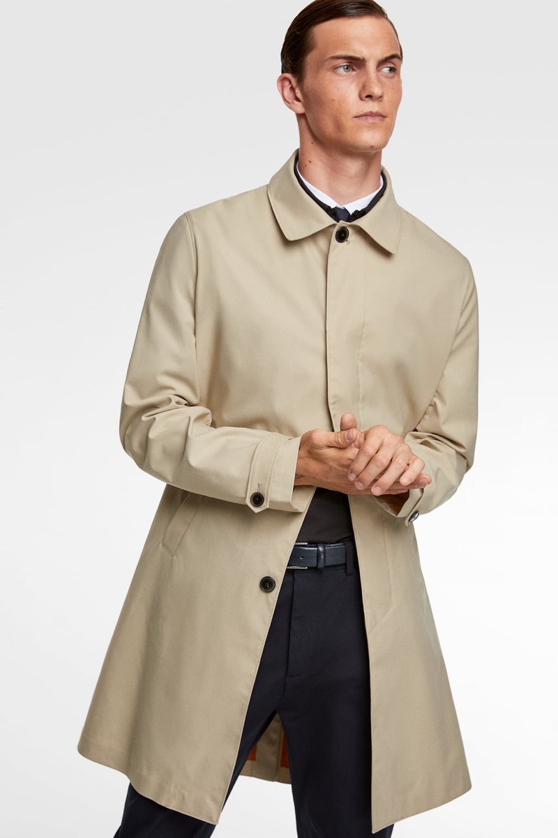 Wearing a smart trench, Luc Defont-Saviard highlights standout styles from Zara Man's traveler collection.