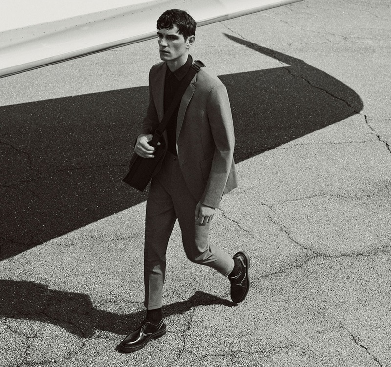 On the move, Julien Sabaud dons a smart suit from Zara's Traveler collection.