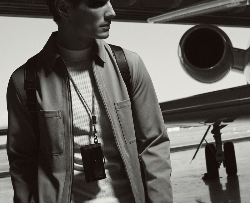 Captured in a black and white photo, Julien Sabaud dons a jacket and top from Zara's Traveler collection.