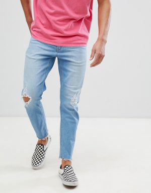 ASOS DESIGN tapered jeans in vintage light wash with rips - Blue ASOS DESIGN tapered jeans in vintage light wash with rips - Blue