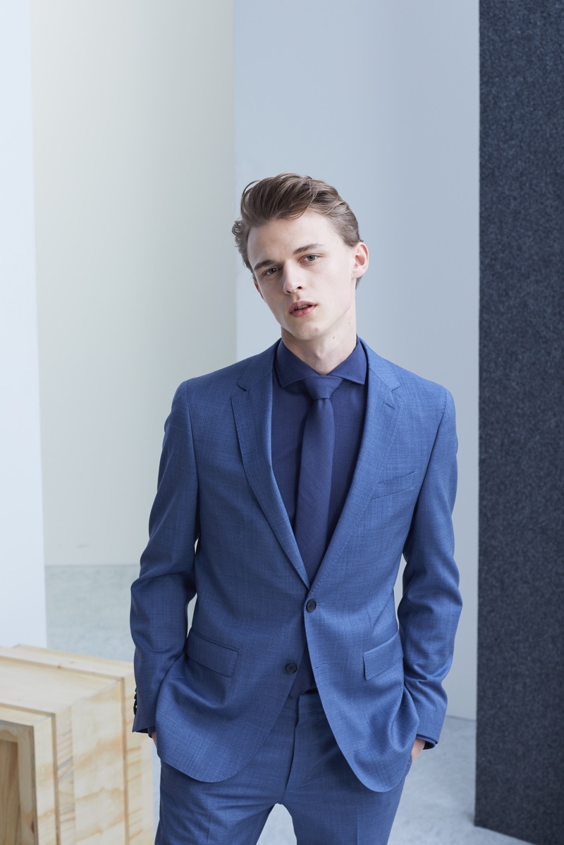 Max Barczak dons an elegant two-button suit, shirt, and tie from BOSS' Traceable Wool men's capsule collection.