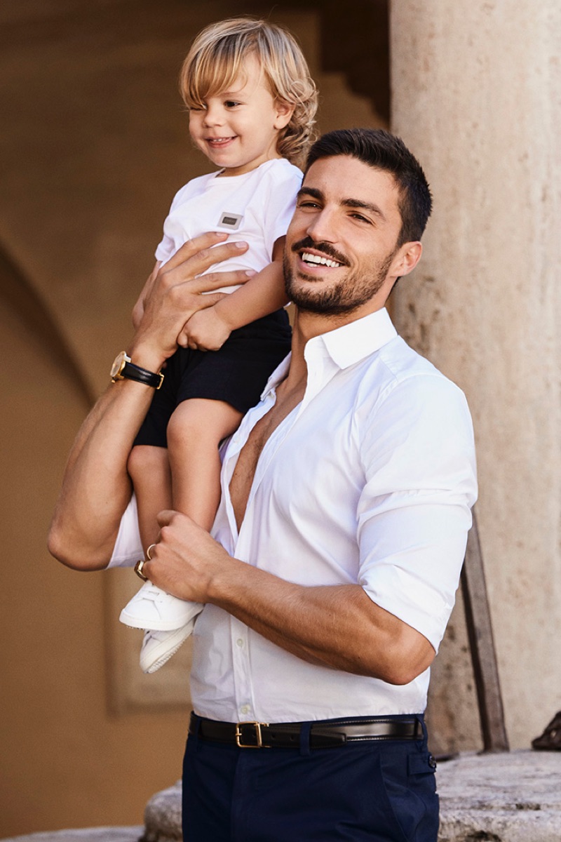 Captured behind the scenes, Mariano Di Vaio poses for a photo with his son.