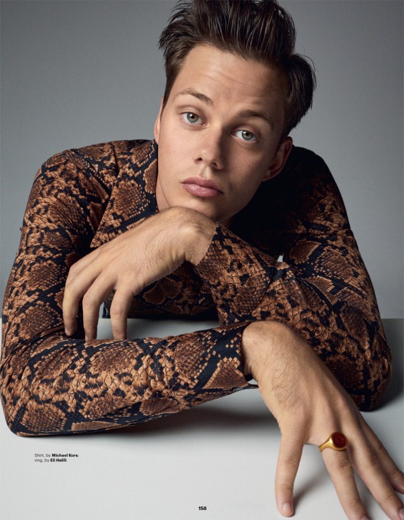 Actor Bill Skarsgård wears a Michael Kors reptile print shirt with a ring by Eli Halilli.