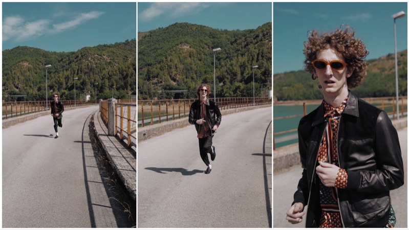 On the move, Alexiey Barbaro dons a leather jacket and printed shirt by C.9.3.