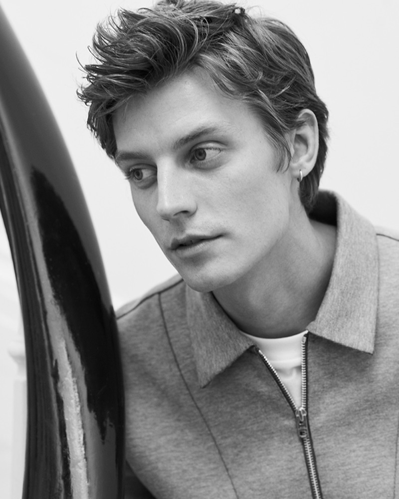 Model Janis Ancens dons a grey Club Monaco zip mock sweatshirt $179.50.