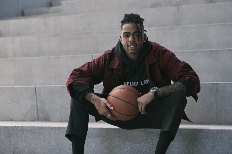 D'Angelo Russell sports an Alexander Wang red snake print denim jacket with a Helmut Lang hoodie, Barena cargo pants, and a Shinola watch for Bloomingdale's fall 2019 Mix Masters campaign.