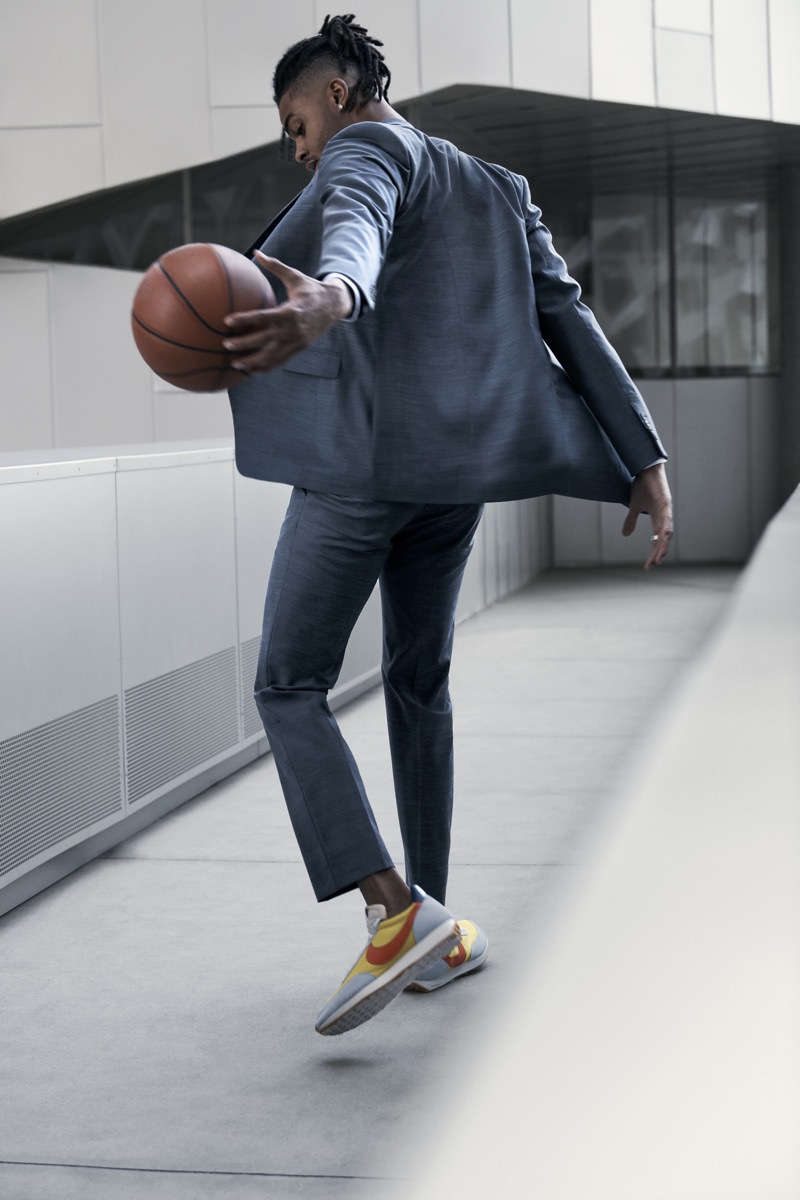 Dribbling a basketball, D'Angelo Russell dons a Theory suit.