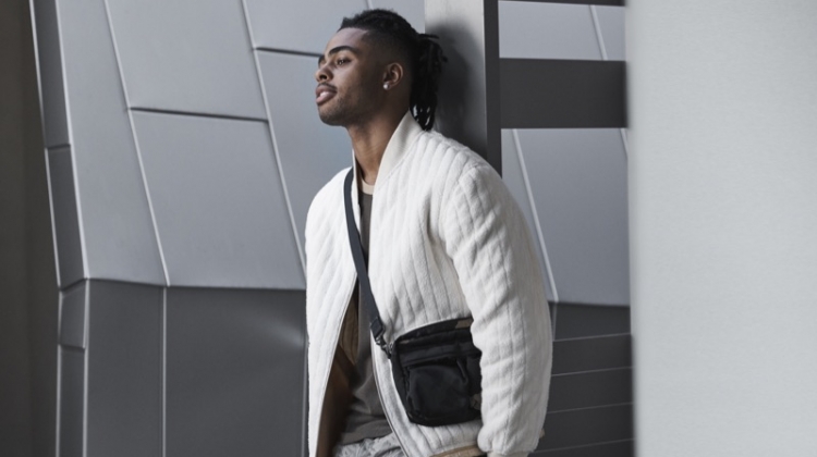Starring in Bloomingdale's Mix Masters fall 2019 campaign, D'Angelo Russell sports a Helmut Lang fleece bomber jacket and t-shirt. He also rocks J Brand cargo pants in a camouflage print with Salvatore Ferragamo sneakers and a Porter sling bag.