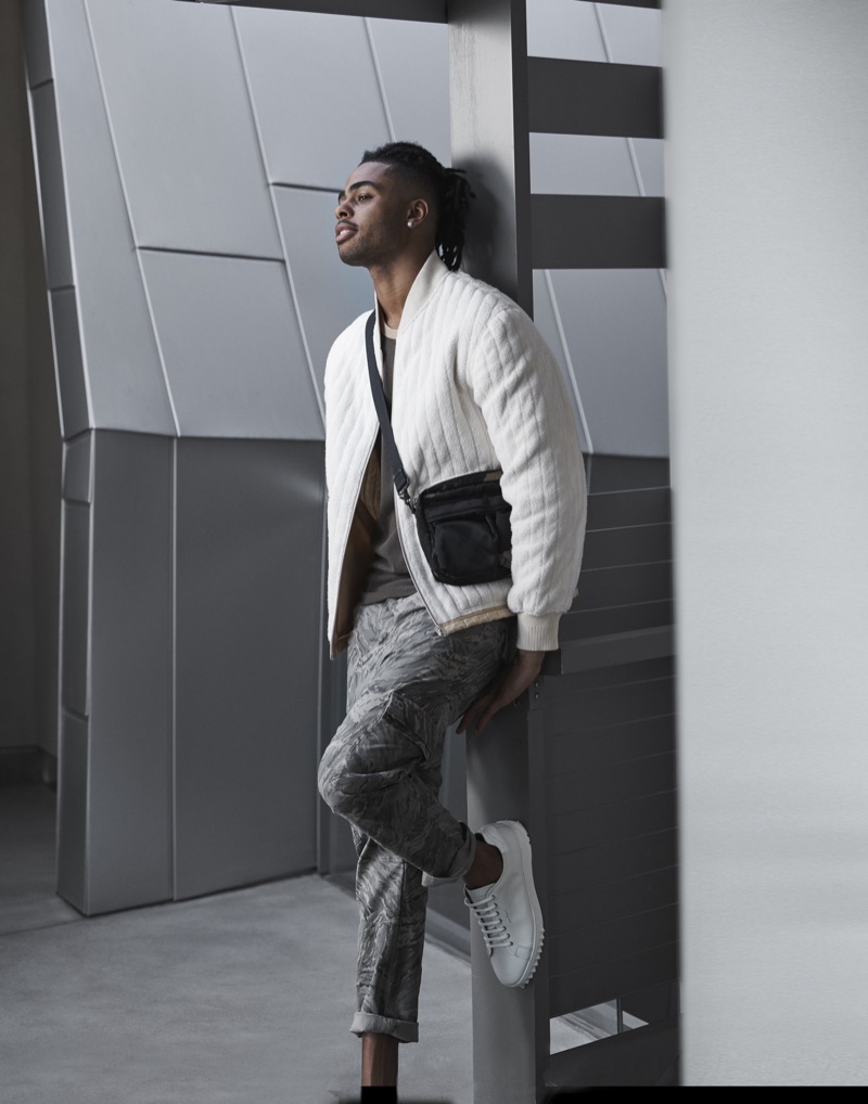 Starring in Bloomingdale's Mix Masters fall 2019 campaign, D'Angelo Russell sports a Helmut Lang fleece bomber jacket and t-shirt. He also rocks J Brand cargo pants in a camouflage print with Salvatore Ferragamo sneakers and a Porter sling bag.