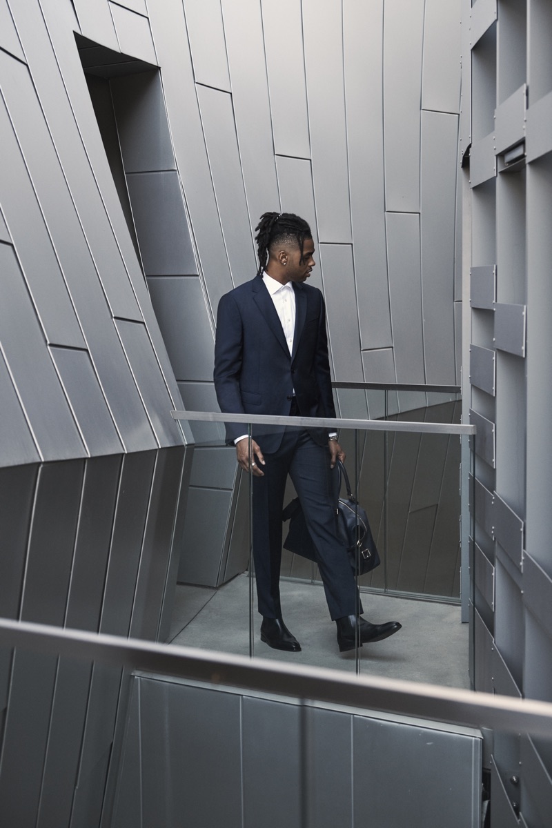 Suiting up, D'Angelo Russell dons a Z Zegna suit in navy with an Eton shirt, Paul Smith Chelsea boots, and a Smythson duffel.