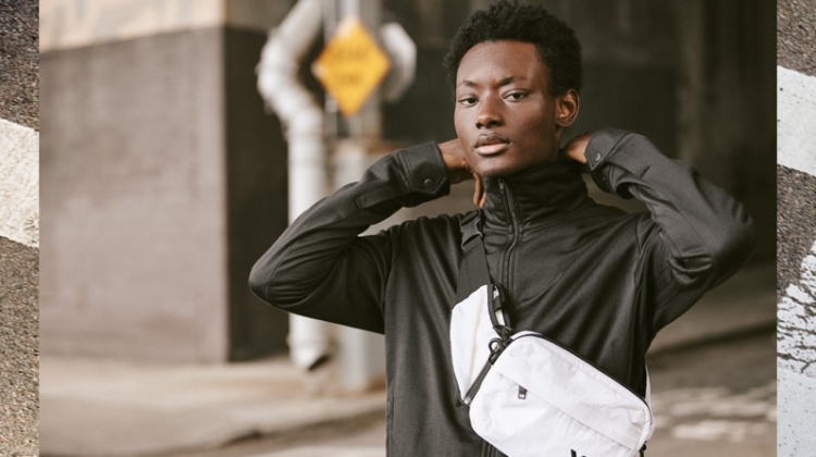Reuniting with East Dane, Youssouf Bamba sports a Y-3 track jacket, cropped pants, and sling bag.