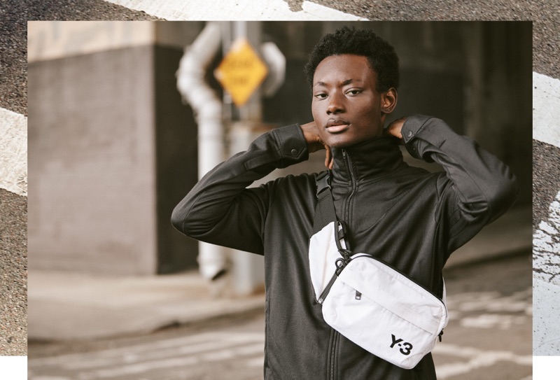 Reuniting with East Dane, Youssouf Bamba sports a Y-3 track jacket, cropped pants, and sling bag.