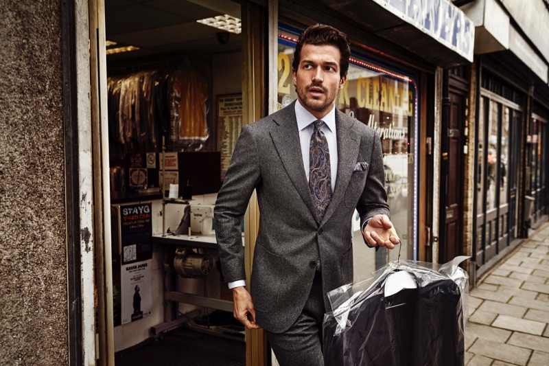Paul Kelly dons a sharp suit as he showcases a dress shirt from Eton's holiday 2019 collection.
