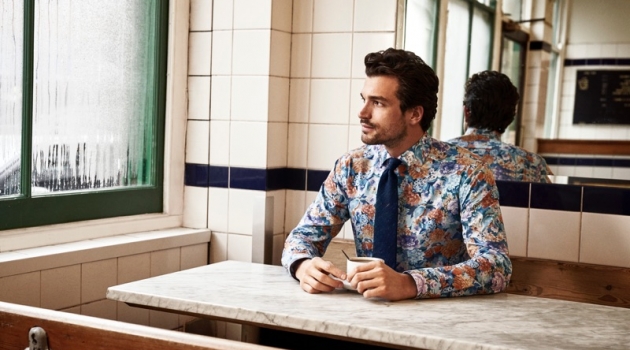 Paul & Sacha Charm in Dapper Shirts for Eton Holiday '19 Collection Enjoying a cup of coffee, Paul Kelly models a patterned shirt from Eton's holiday 2019 collection.
