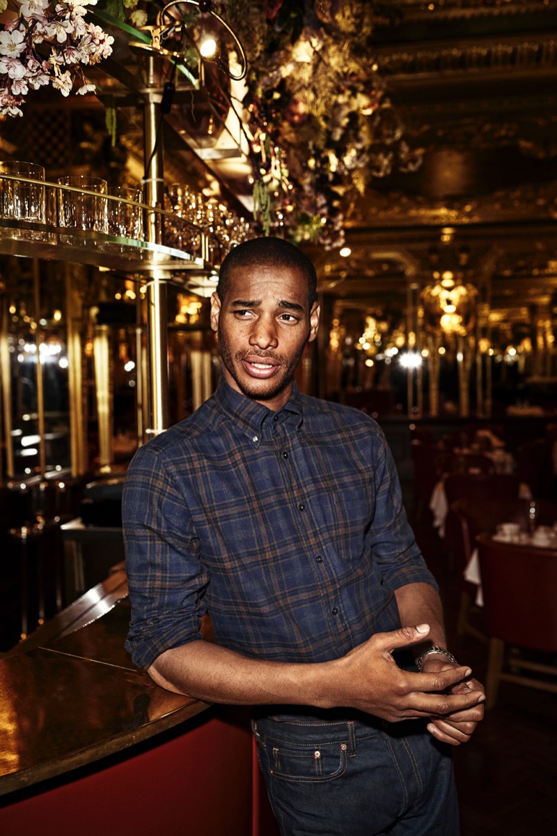 Connecting with Eton, Sacha M'Baye wears a checked shirt for the holiday season.