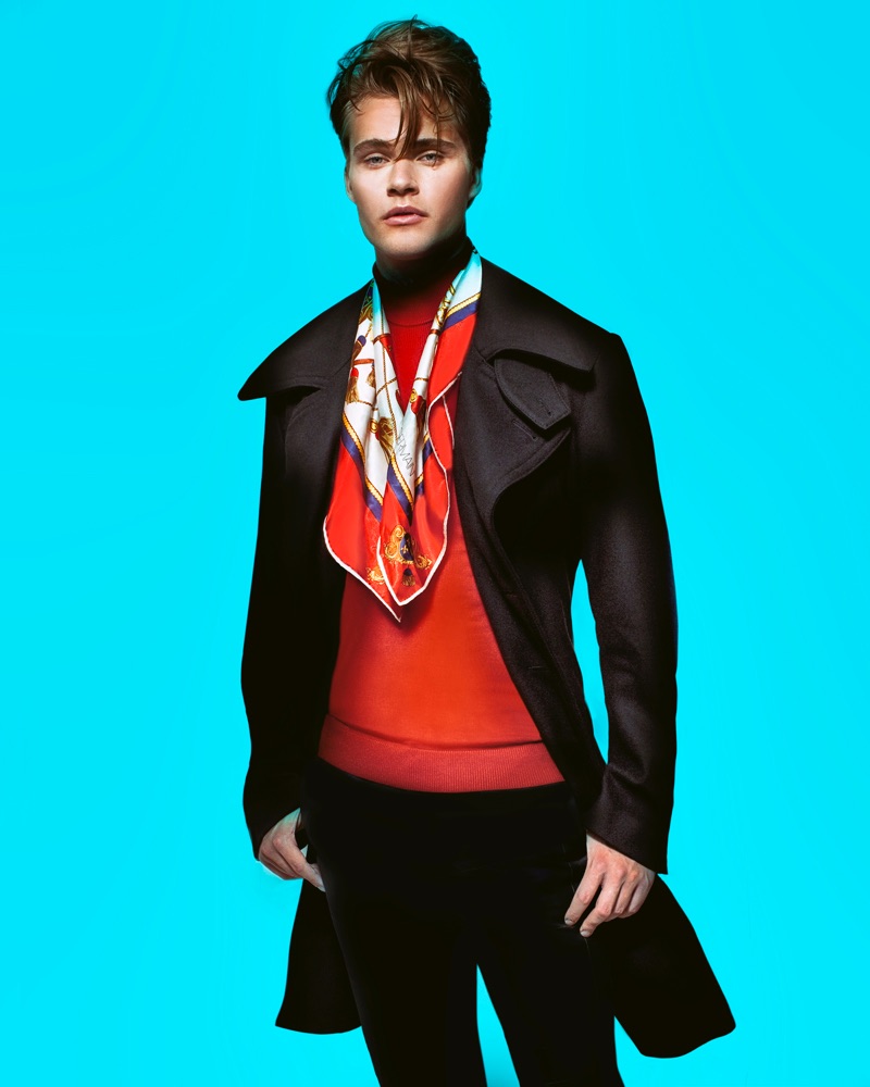 Konrad wears red turtleneck Simons, trench Dsquared2, pants Paul Smith, scarf Christian Dior, and watch Michael Kors.