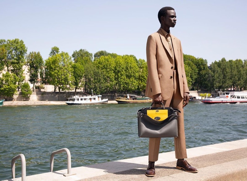 Malick Bodian takes hold of Fendi's leather Peekaboo bag in yellow and black.