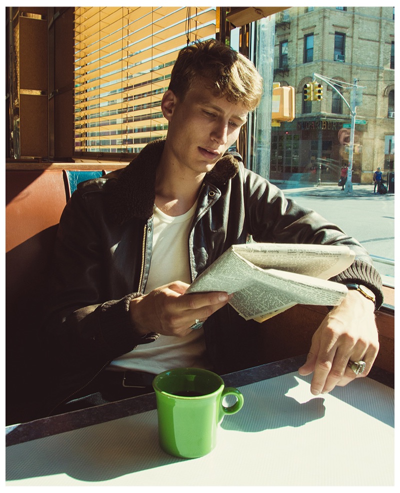 Reading the newspaper, Caleb Fechtor dons a tank from Hemen Biarritz.