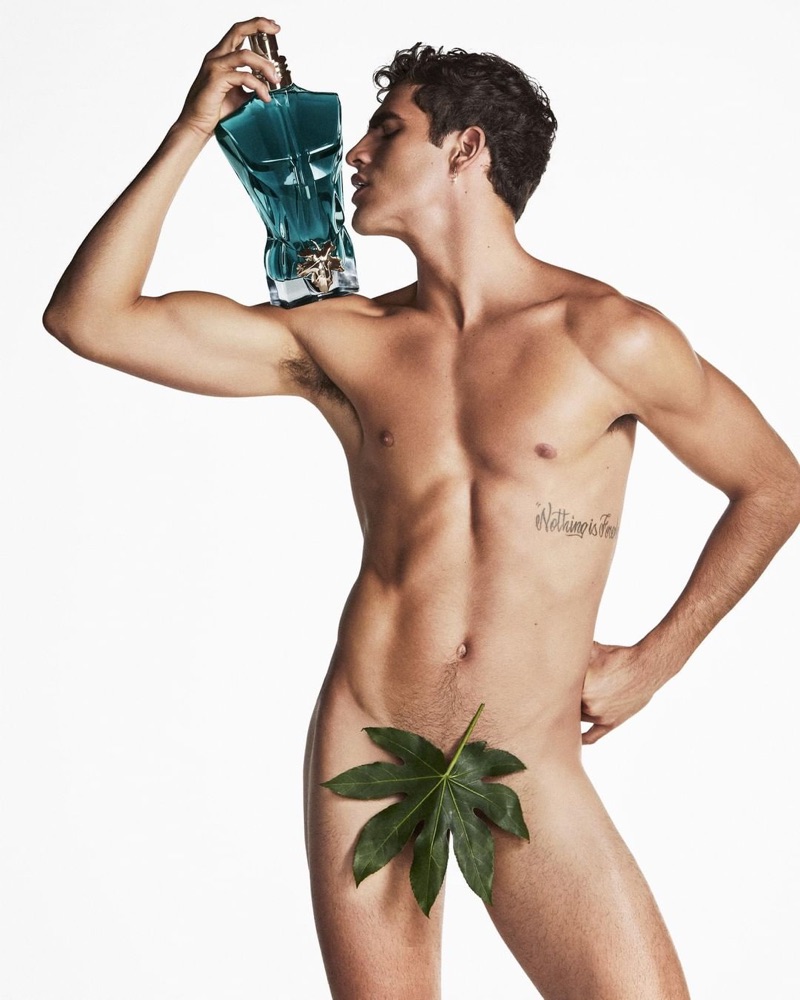 Brazilian model Jhonattan Burjack poses naked with a bottle of Jean Paul Gaultier's Le Beau.