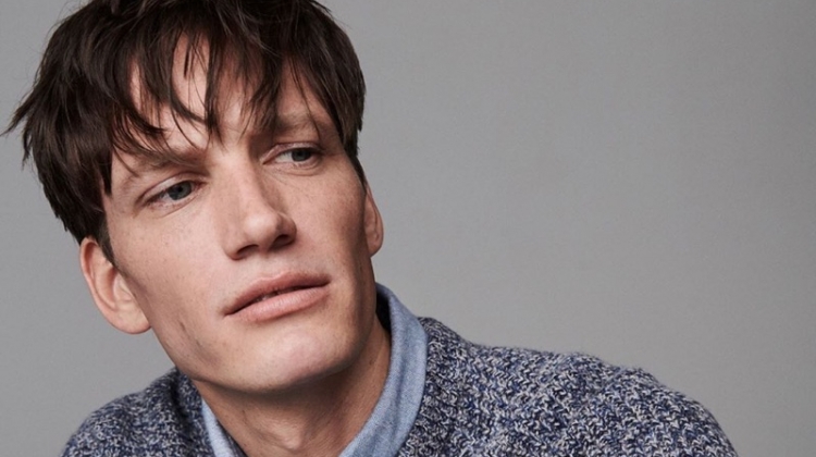 Florian Van Bael dons a smart shirt and sweater from Jigsaw's fall-winter 2019 men's collection.