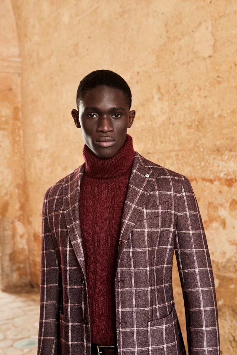 A chic vision, Paco Diouf dons an ensemble in wine-colored hues from L.B.M. 1911's fall-winter 2019 collection.