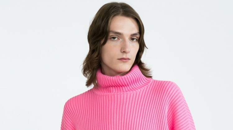 Alex Rychkov sports a pink ribbed Balenciaga turtleneck sweater $1290 and Versace jeans $525.