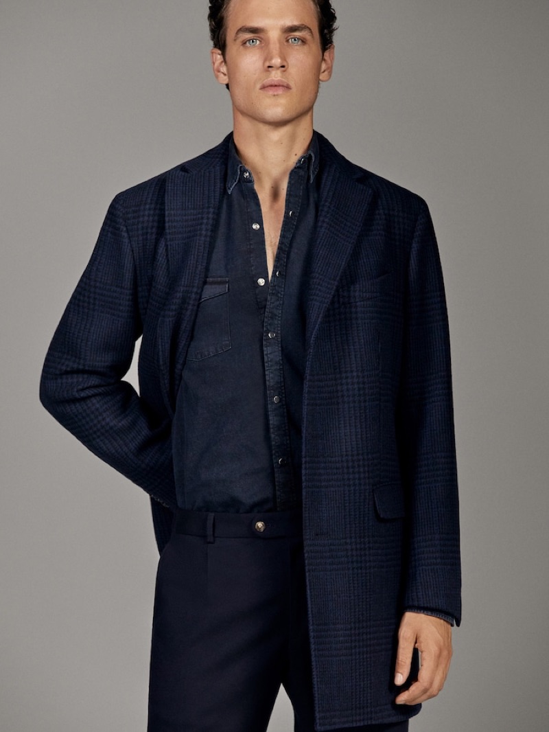 Front and center, Federico Novello dons a navy number from Massimo Dutti's fall-winter 2019 runway collection.