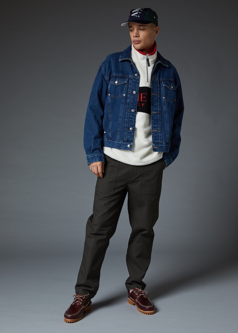 Making a case for sporty style, Lancelot Prat wears a Perry Ellis logo denim jacket and half-zip sweatshirt.